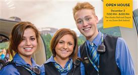  3 students dressed in AK Railroad uniforms with a train in the backgroud.